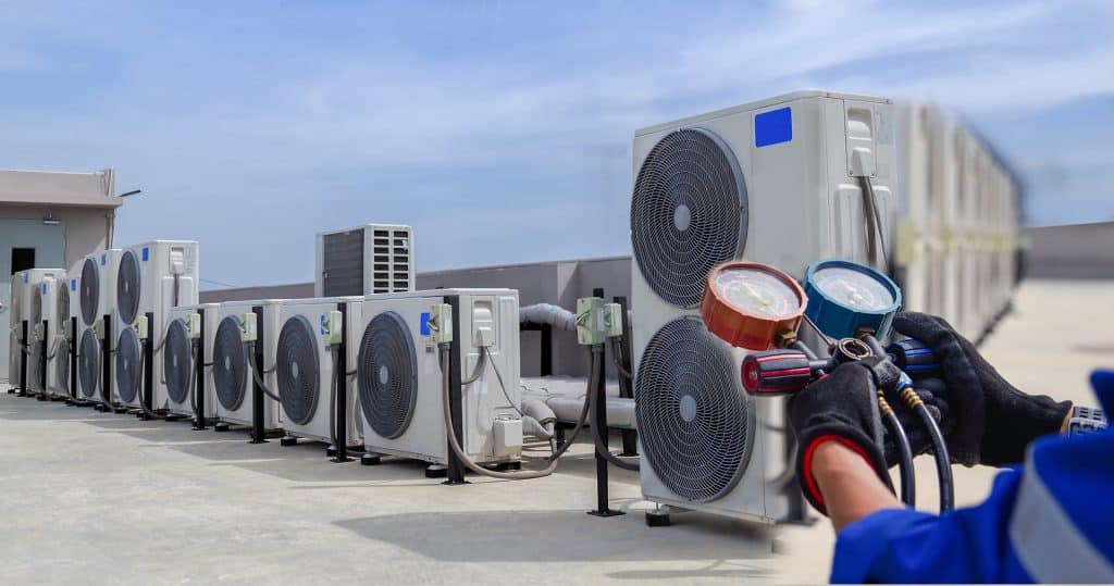 AC technician checking refrigerant levels during repair service in Melbourne FL
